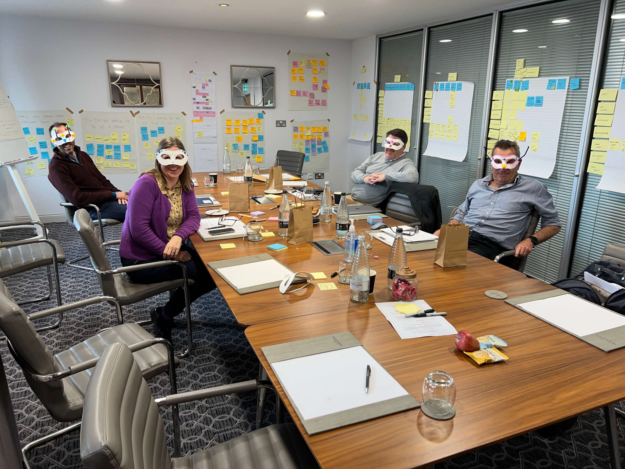 Three vets and one consultant wearing decorated eye masks in a recruitment workshop. Cementing the importance of always looking behind the mask when interviewing.